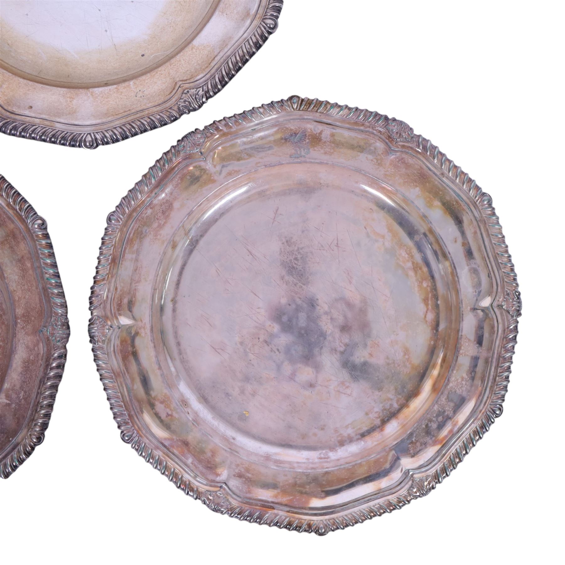 Set of three late 19th century Mappin Brothers silver plated plates, the pie crust rims with oblique gadrooned edge, each engraved with dragon armorial crest, D26cm