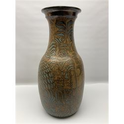 John Egerton (c1945-): studio pottery stoneware vase decorated with cranes in a riverscape upon a mottled brown ground, signed beneath H60cm