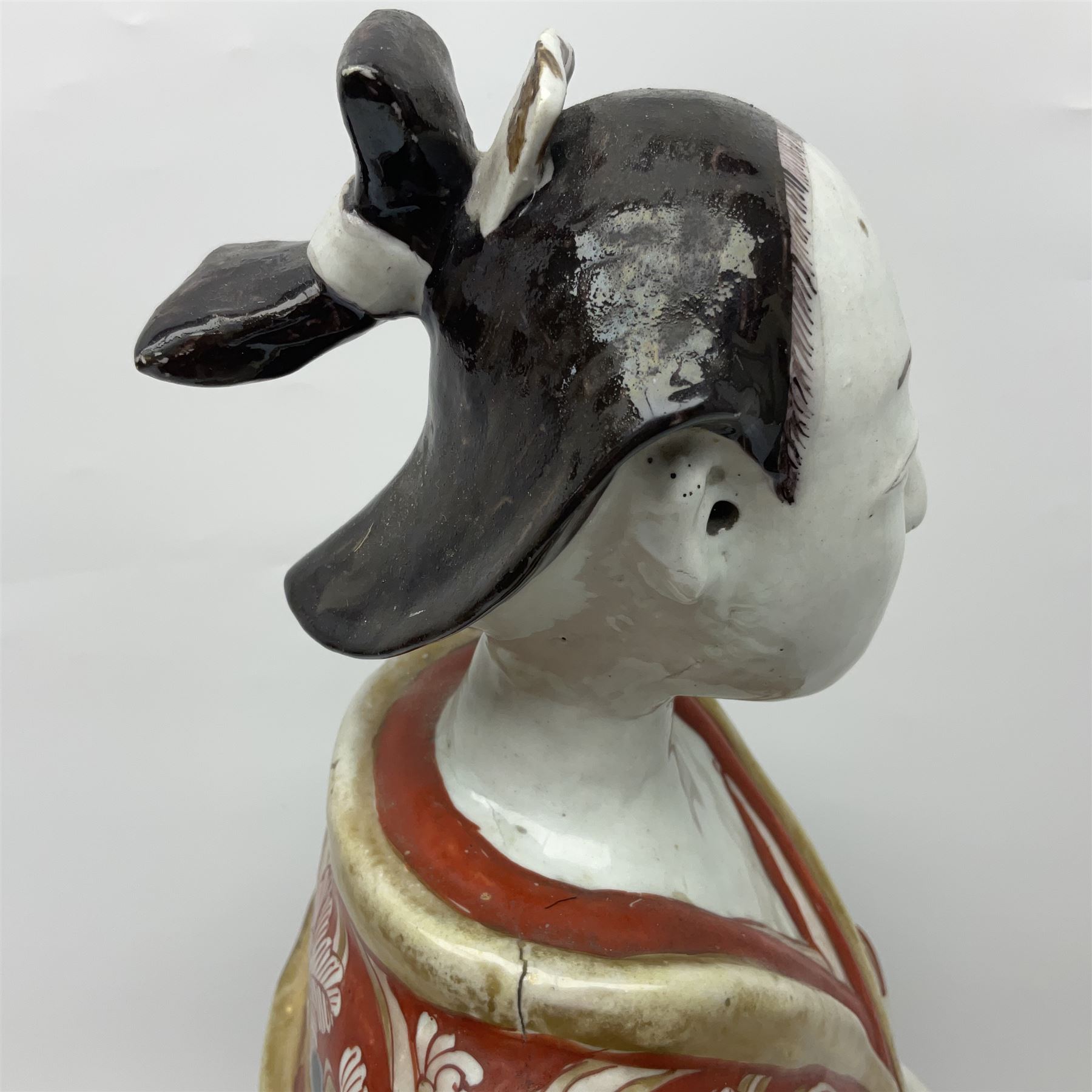 Large Japanese Imari porcelain figure, modelled as a Bijin, wearing a long kimono decorated with apple blossom and leafy branches on a white ground, with gilt detailing, possibly Edo period, H63cm