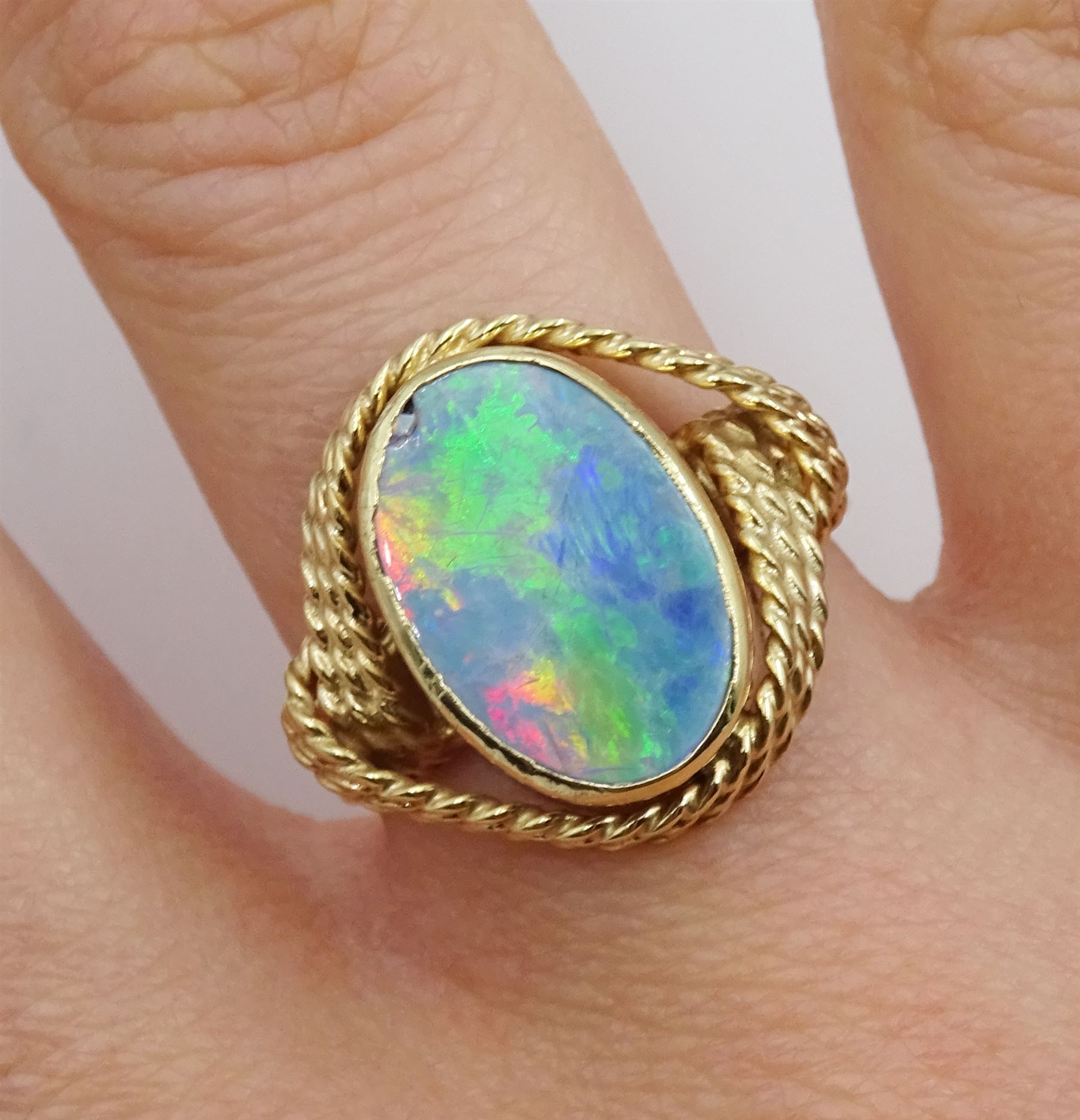 Gold oval opal doublet ring with rope twist design gallery, stamped 9ct