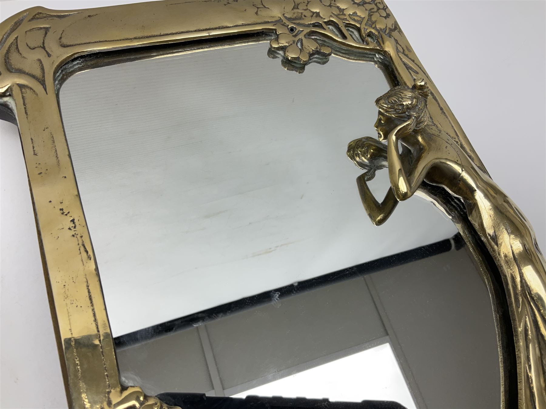 Art Nouveau style mirror in the manner of WMF, decorated with a female figure and floral motifs, the easel support verso with spurious WMF, H35cm