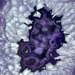 Pair of purple agate slices, polished with rough edges raised upon gilt metal stands