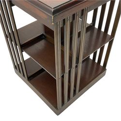 Edwardian revival inlaid mahogany revolving bookcase, square form with moulded top inlaid with central fan motif, two-tiers with moulded upright rails, on castors 