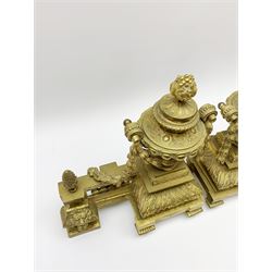 Victorian brass fire kerb, the pierced central rail leading to bracket ends with lion mask detail and urn finials draped with husk swags, H32cm, W117cm