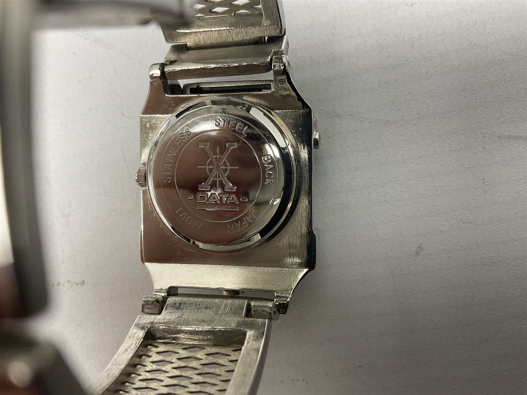 Four X Data stainless steel wristwatches, two Marc Gay wristwatches and one other, all with cover plates