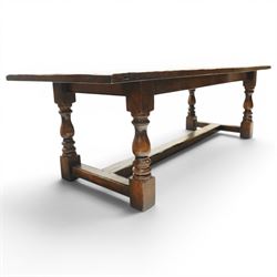 17th century design 8ft dark oak refectory dining table, the rectangular top raised on four turned baluster supports united by H-stretcher