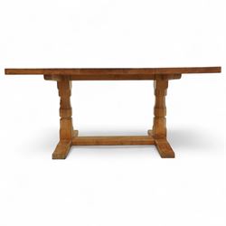 Mouseman - figured oak 5’ refectory dining table, rectangular top with burr figuring, raised on chamfered octagonal supports united by a stretcher, carved mouse signature to leg, by the workshop of Robert Thompson, Kilburn