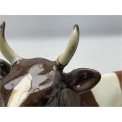 Five Beswick figures of cattle Comprising Ayrshire Bull Ch Whitehill Mandate, no 1454B, three Ayrshire Cow Ch Ickham Bessie, no 1350 and Ayrshire Calf, no 1249B, all with printed marks beneath