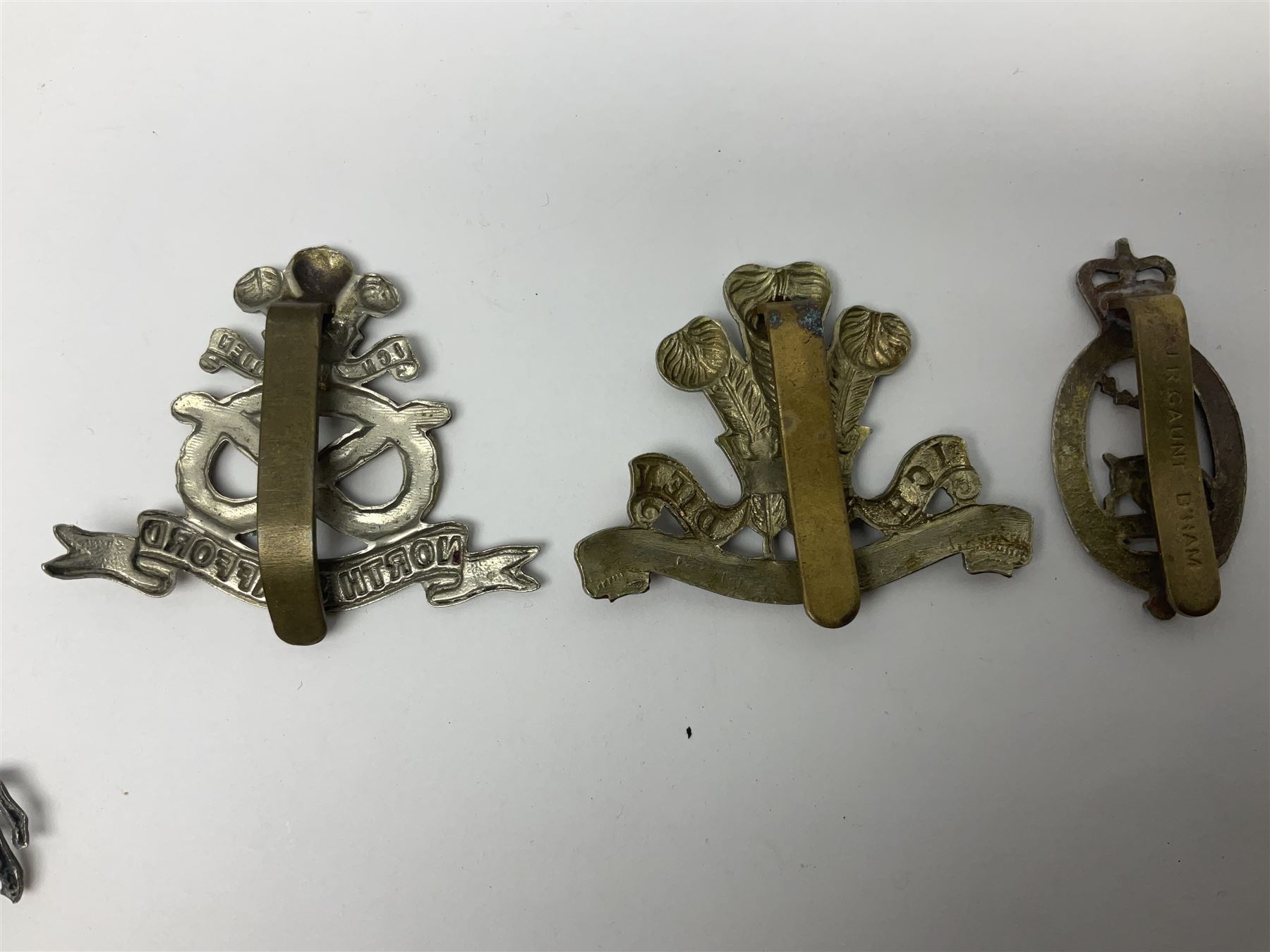 Nineteen Yeomanry metal cap badges including Derbyshire, Northamptonshire, Essex, Glamorgan, Staffordshire, City of London, Surrey, Shropshire, Hertfordshire etc; together with eleven Fusiliers badges including Lancashire, Royal Welch, Northumberland etc (30)