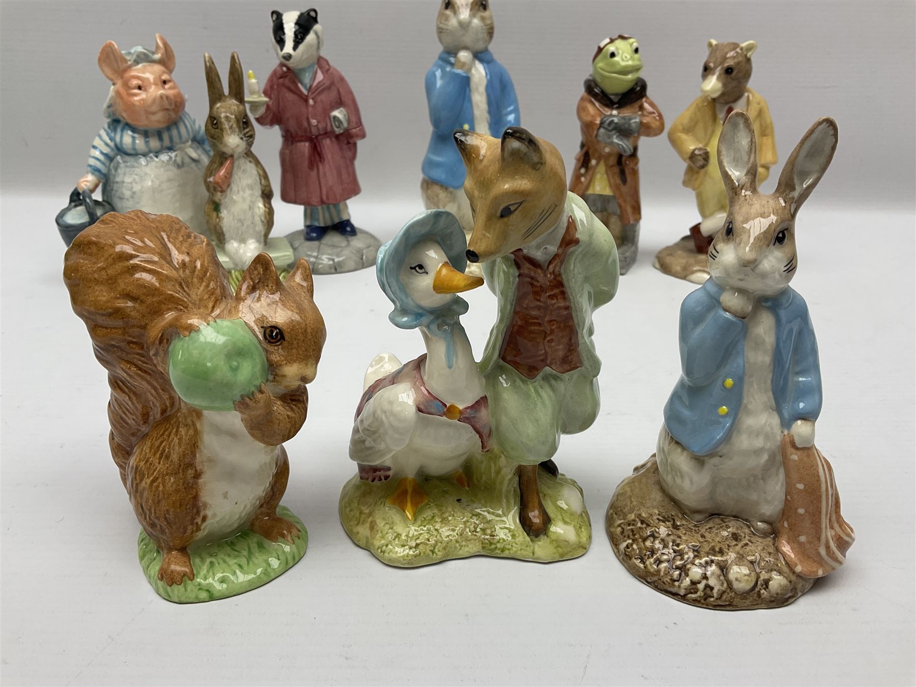 Sixteen Royal Albert Beatrix Potter figures, including Poorly Peter Rabbit, Jemima Puddle Duck and Squirrel Nutkin etc, all boxed together with a Beswick Beatrix Potter Jeremy Fisher miniature jug and four Beswick Wind in the Willows figures 