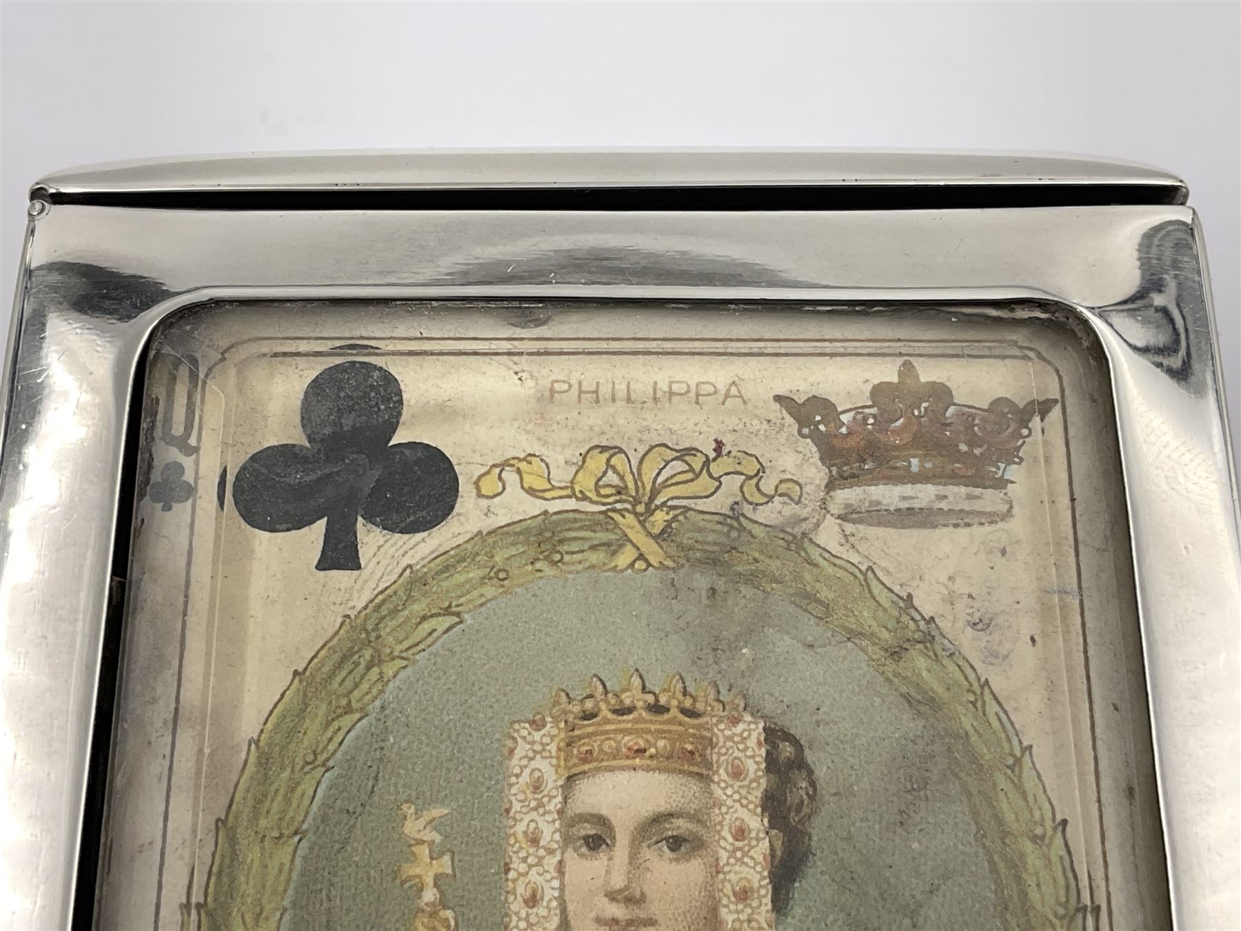 Edwardian silver mounted playing card case, hallmarked William Harrison Walter, Birmingham 1903, the sides each with a period playing card set behind a bevelled glass panel, the hinged cover with later engraving 'Presented to Norman T Crombie Esq by the officers & men of the 31st WR Detachment for services rendered 1917-1918', with red leather lined interior, the three compartments upon a sprung base and containing two later wooden Whist markers, case H12.5cm