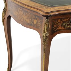 Late 19th century French kingwood and marquetry bureau plat, the serpentine rectangular top with green leather inset writing surface within crossbanded and foliate marquetry border, above a shaped frieze fitted with three drawers with floral marquetry panels and gilt metal handles, upon cabriole supports with applied gilt metal mounts and sabots