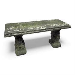 Weathered cast-stone garden bench with squirrel designed supports and rectangular top