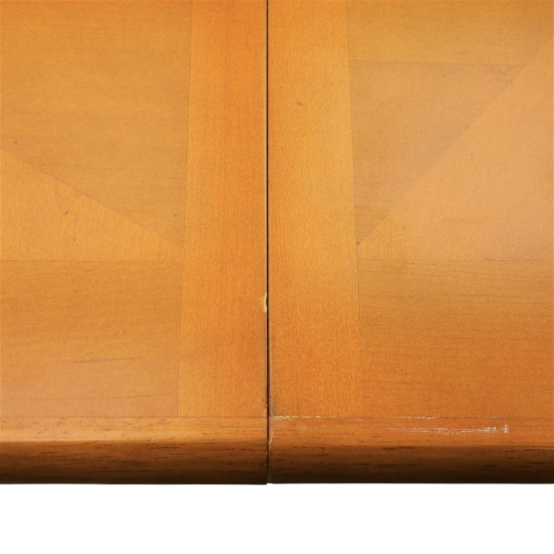 Modern Art Deco design walnut extending dining table, rectangular top with rounded moulded edge, geometric parquetry veneered panels, extending action with additional leaf extending to 220cm, on twin panelled pedestal supports with stepped plinth feet