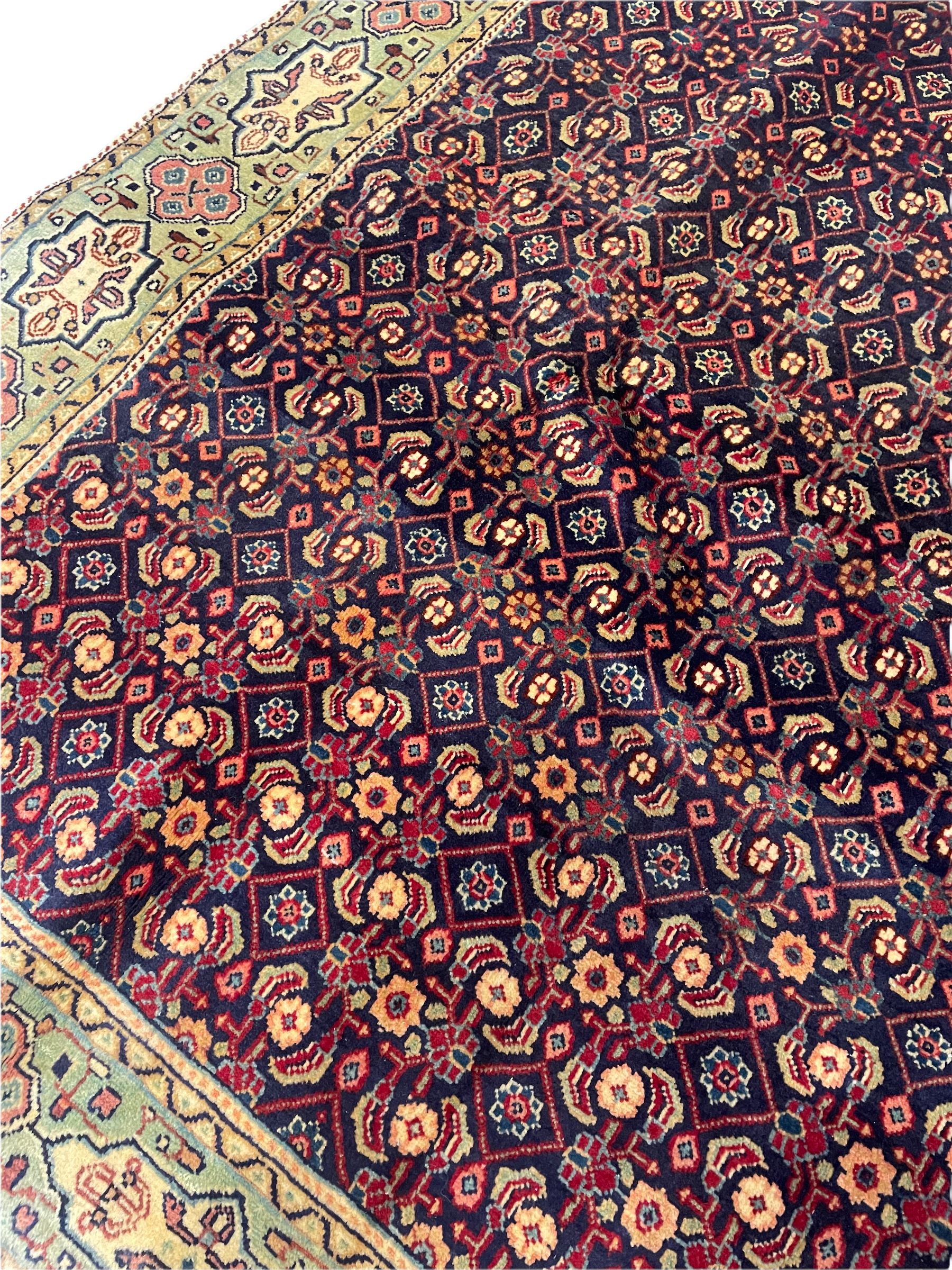 Persian Mahal rug, the blue ground field decorated with repeating Herati motifs, guarded pale ground border decorated with stylised panels