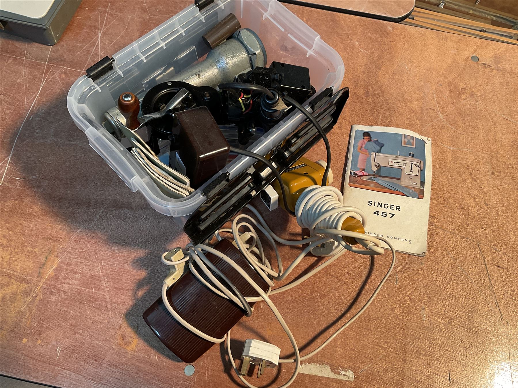 Two Singer sewing machines, model numbers 527 and 457, together with various Singer sewing machine parts, and a selection of sewing related accessories, to include threads, sewing needles, etc.