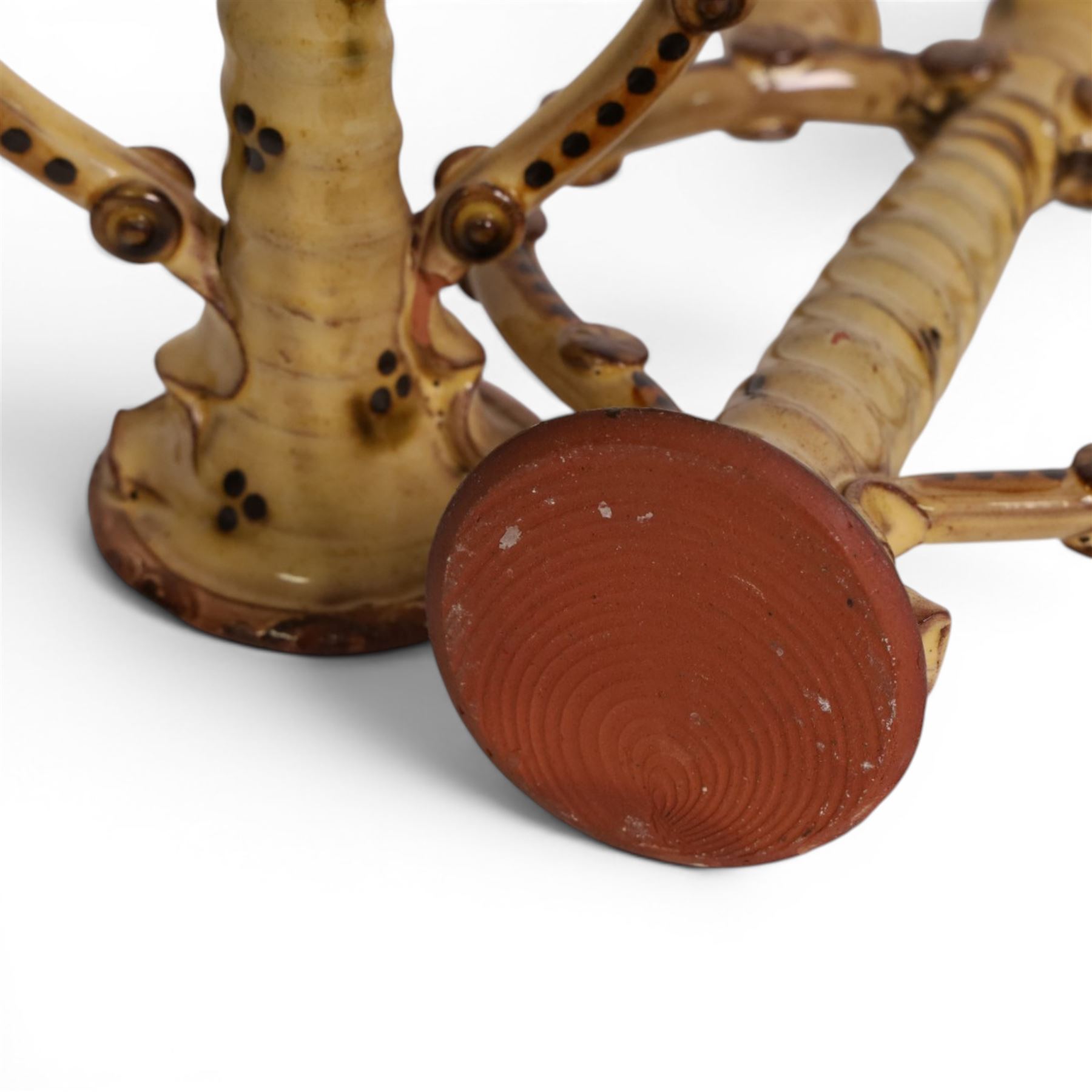 Pair of studio pottery candlesticks, with a central twisted column bordered by circular supports, H24cm 
