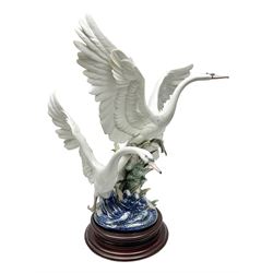 Large Lladro figure group, Swans Take Flight, modelled as two swans upon raised on circular wooden plinth, sculpted by Salvador Debon, H68cm