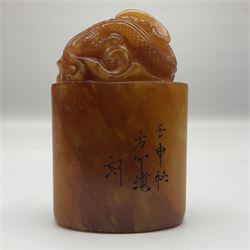 Chinese amber soapstone seal of oval form,  carved temple dog finial, inscription on the back and base, H12cm