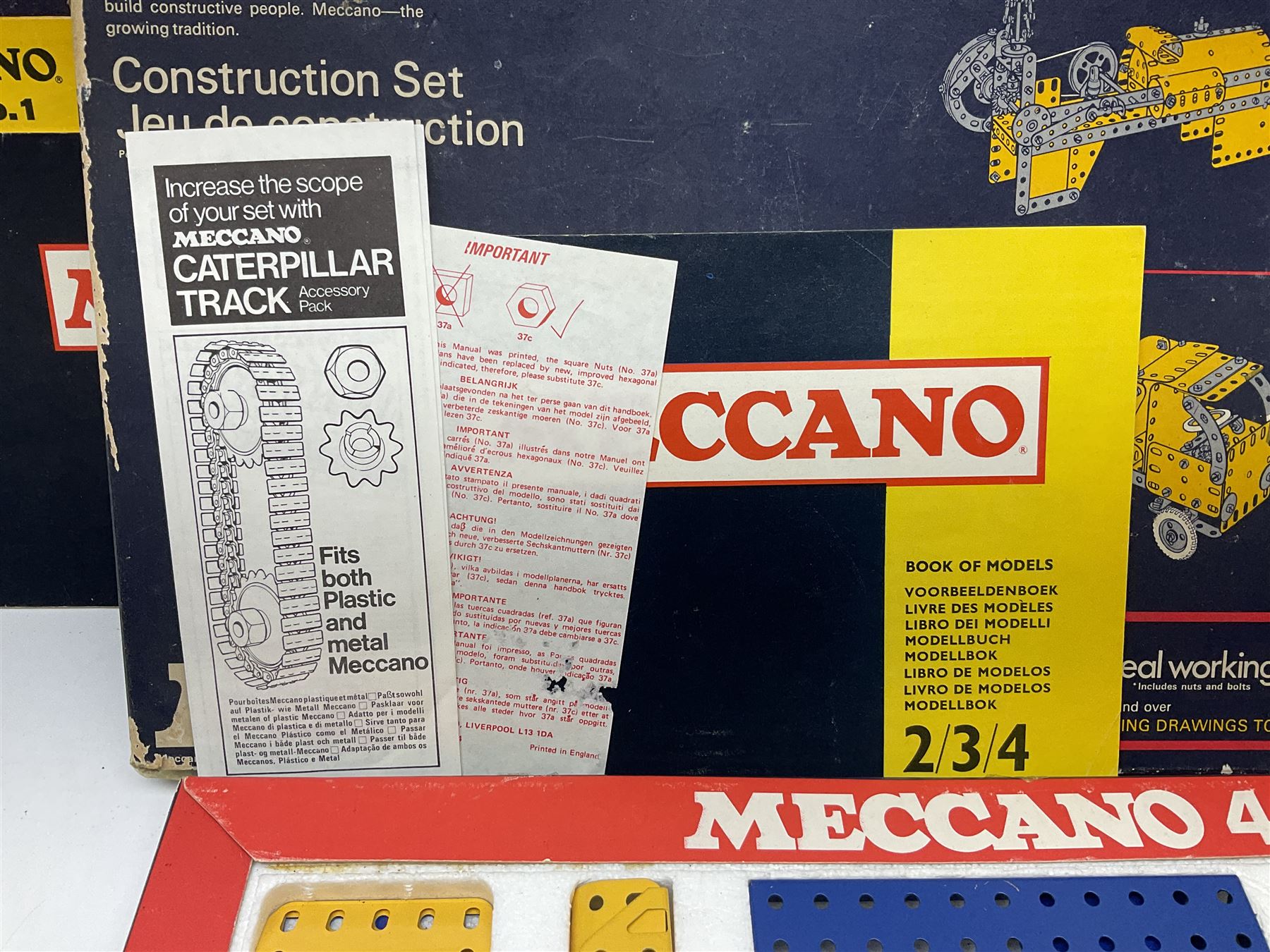 Meccano - Outfits 2, 3 & 4 with blue and yellow parts; look to be virtually complete with most apertures filled; together with a partially stocked Meccano Elekrikit; all boxed with instruction manuals (4)