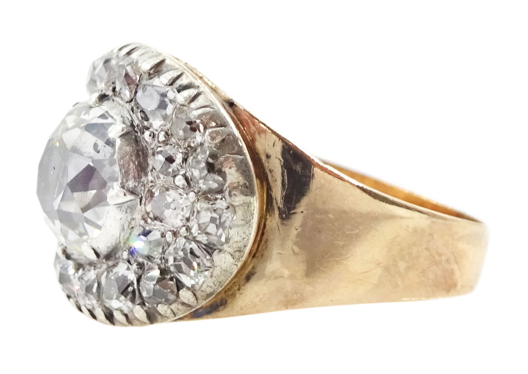 George III gold and silver old cut diamond cluster ring, the principal diamond of approx 0.75 carat, with pave set old cut diamond surround

