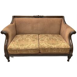 Victorian design mahogany two-seat sofa, the cresting rail carved with foliage scrolls, curved and sweeping arms with acanthus carved terminals, on turned and acanthus carved feet