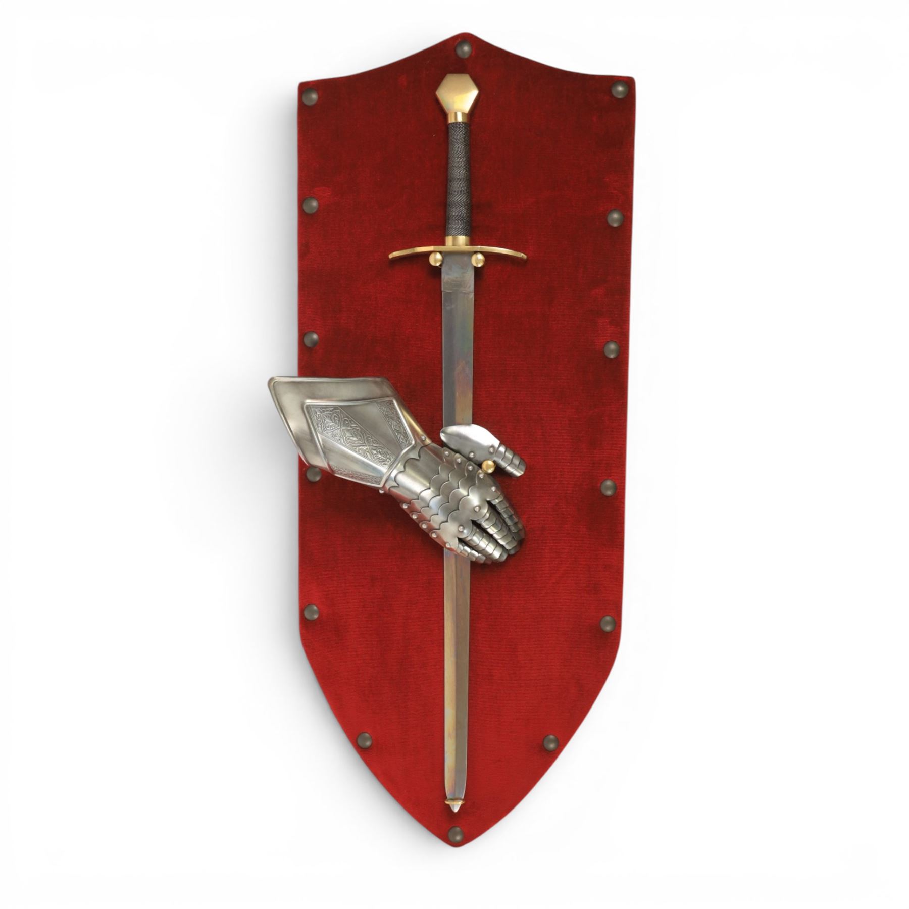 Three replica gauntlets, each housed upon a red wall shield, two with daggers, the third with a sword, largest H102cm