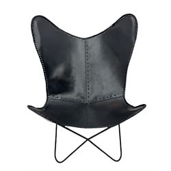 Metal framed butterfly chair upholstered in slung dark tan stitched leather 