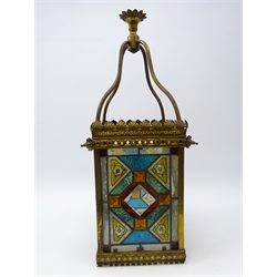  Victorian leaded glass square hall lantern, four stained glass panes with geometric and floral design, pierced gilt metal frame with four arching supports, H63cm   