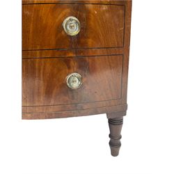 Early 19th century mahogany converted bow-front commode, hinged top with reeded edge, lifting to reveal shelf interior over a cellarette base, fitted with pressed brass plates and ring handles, with ebony stringing in the form of faux drawers, on ring turned feet