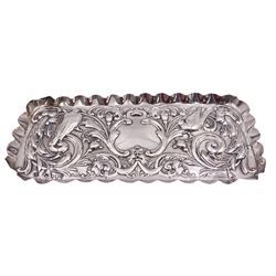 Victorian silver dressing table tray, of rectangular form with lobed edge and repousse decoration of foliate scrolls, flower buds and two birds, hallmarked hallmarked Goldsmiths & Silversmiths Co, London 1895, L23cm, approximate weight 3.90 ozt (121.5 grams)