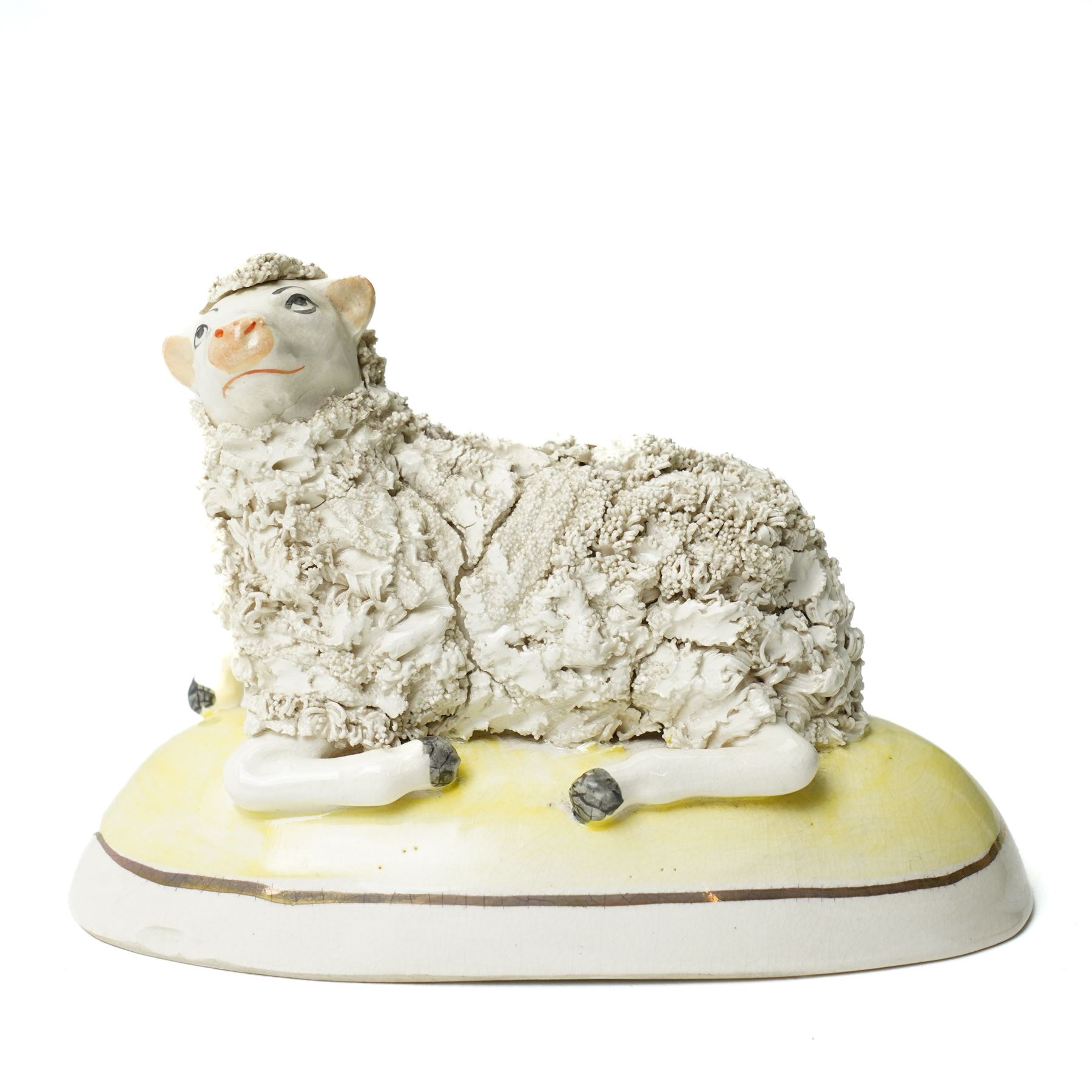 Pair of 19th century Staffordshire sheep, W13cm; together with a pearlware bocage group, H12cm (3)