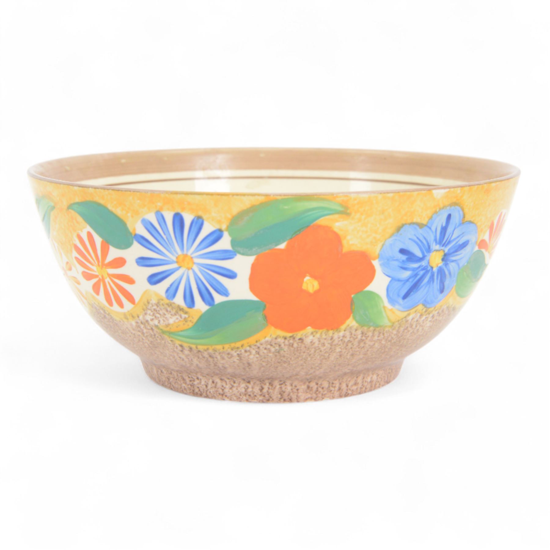 1930s Clarice Cliff Bizarre for Newport Pottery bowl, decorated in the Canterbury Bells pattern, the exterior painted with stylised flowers in blue, yellow and orange amongst foliage upon a brown and yellow Cafe au Lait stippled ground, with black printed mark beneath, D18cm