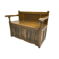 20th century oak monk's bench settle, hinged box seat over panelled front with carved arch decoration