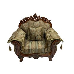 Italian Baroque design armchair, hardwood framed, the cresting rail carved and pierced with c-scrolls and flower heads, scrolled arms, upholstered in floral patterned and striped fabric, with scatter cushions 
