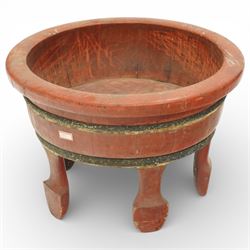 Chinese red painted wooden wash bowl, of circular form with a thickened rim above a tapering body with painted bands, raised on five short supports