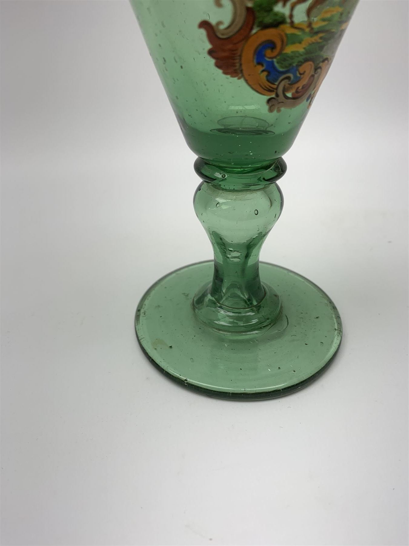 19th century bohemian green glass wine glass, the funnel bowl decorated in enamells with a Historismus hunting scene in the manner of Egermann & Lobmeyr, upon a baluster stem and circular foot, H14.5cm