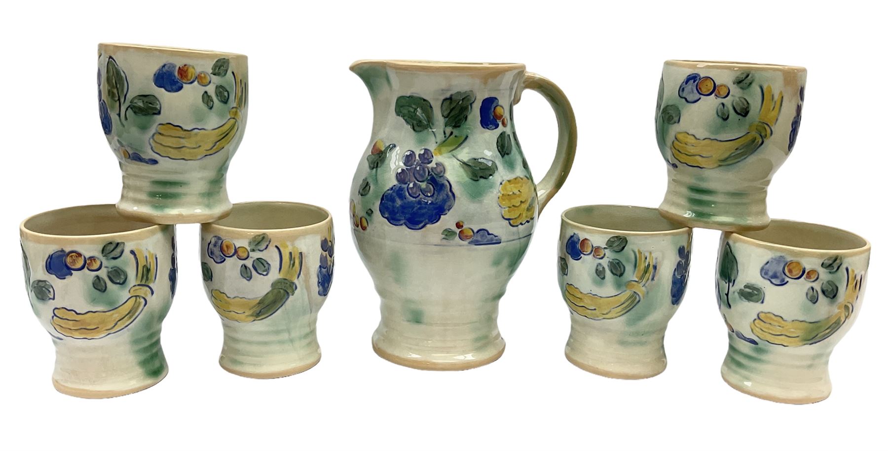 Early 20th century Royal Doulton Brangwyn Ware jug and set of six beakers, designed by Frank Brangwyn RA, all decorated in the Harvest pattern with stylised leaves and fruit on mottled peach and green ground, all with printed marks beneath, date code for 1920s, largest H18cm