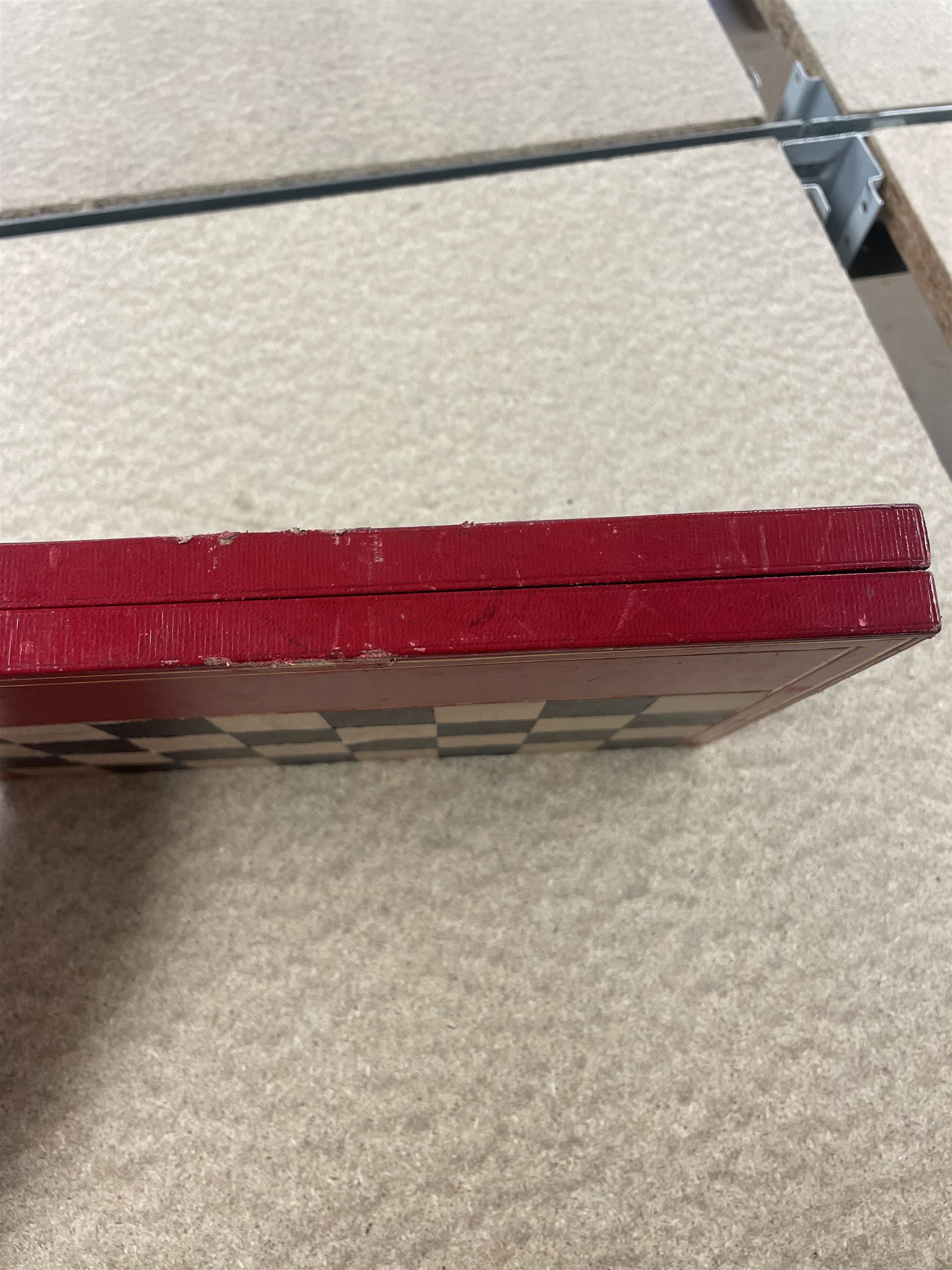 19th century walnut and brass bound games compendium box, painted to enhance the grain, of rectangular form, the hinged opening cover with rounded sides, central brass cartouche with engraved lion crest, and brass riveted straps, opening to reveal a red leather and blue silk lined compartmented interior, with fold-down games board, and lift-out tray containing playing cards, ebony turned dice towers, white and red stained bone draughts, and chess pieces, ivory dice, and ivory and ebony whist markers, and brass bezique board, cribbage board and markers, H15cm W32cm D24cm
This lot has been registered for sale under Section 10 of the APHA Ivory Act