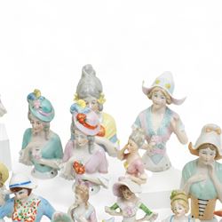 Collection of early 20th century ceramic half dolls, approximately 26, together with two novelty flasks in the form of ladies in evening dresses