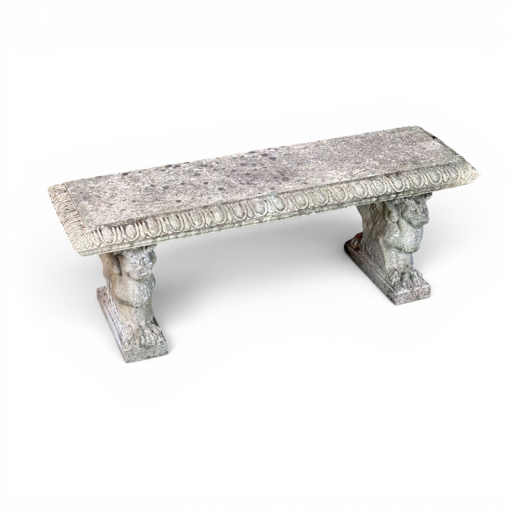 Ornate weathered cast stone rectangular garden bench, raised on winged griffin supports, square plinth bases