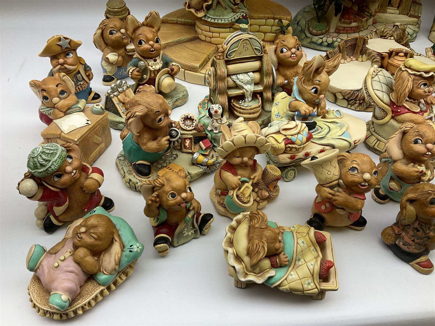 Extensive collection of Pendelfin rabbits and stands, to include Betsy Barge, Fruit Shop, Uncle Soames, Event Piece etc, many with original boxes 