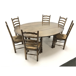  Medium oak oval drop leaf wake dining table on turned gate leg base (L198cm x W156cm, max measurements) and set six ladder back dining chairs with drop in rush seats (W49cm)  