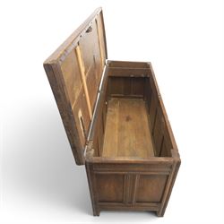 Large 17th century oak coffer, plank top with moulded edge, four panel front with channel moulded uprights, retaining original wrought iron strap hinges and central lock plate, panelled ends, raised on stile supports