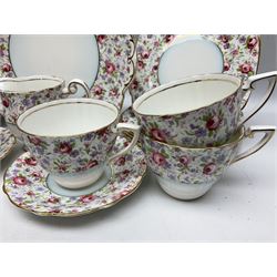 Windsor tea service for six decorated with blooming pink roses and purple flowers amongst foliage