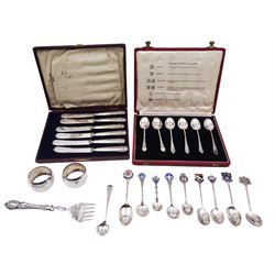 Group of silver, comprising set of six mid 20th century coffee spoons, hallmarked Travis, Wilson & Co Ltd, Birmingham, Chester, Edinburgh, Glasgow and Sheffield 1952, and London 1953, contained within a fitted case, a set of six 1920's silver handled butter knives, hallmarked William Yates Ltd, Sheffield 1922, contained within a fitted case, a pair of early 20th century napkin rings with engraved foliate decoration, hallmarked Joseph Gloster Ltd, Birmingham 1914, a late Victorian silver handled fork, George III salt spoon, and group of assorted souvenir spoons, some with enamelled terminals, various marks including some with British hallmarks, others marked 800, and Sterling, approximate total gross weighable silver 6.49 ozt (201.9 grams)