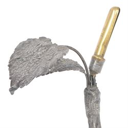 19th century silver plated desk holder, the circular naturalistically modelled base cast with fruiting vines and with applied figure of a ram, rising to a vine with two leaves, and initialled brass clip, H18cm