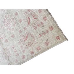 Persian design pale ivory ground carpet, decorated with stylised plant and leaf motifs in pale red