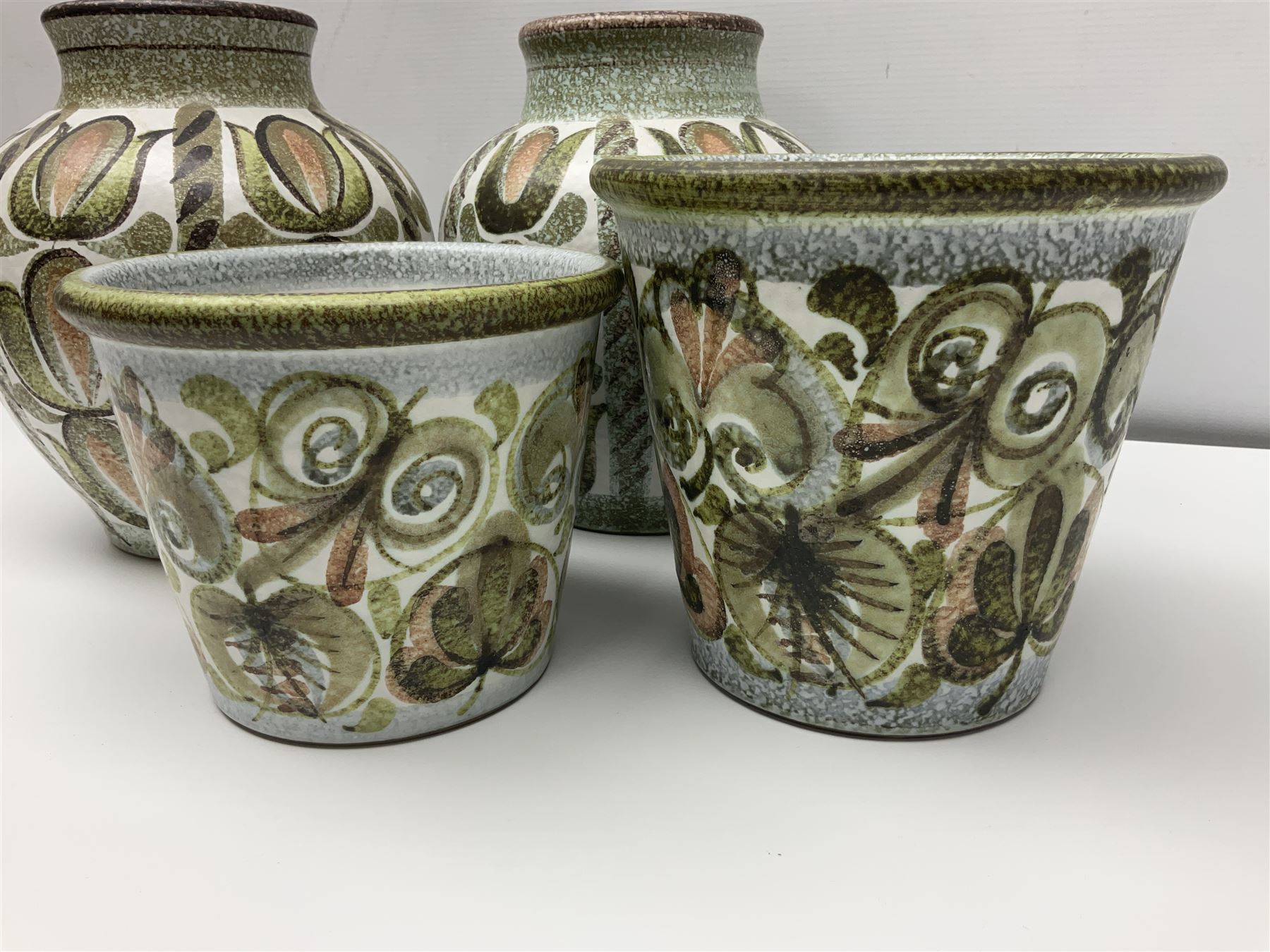 Pair of Denby Glyn Colledge stoneware vases of baluster form with floral decoration over cream ground, together two jardiniere in a similar design, vases H24cm