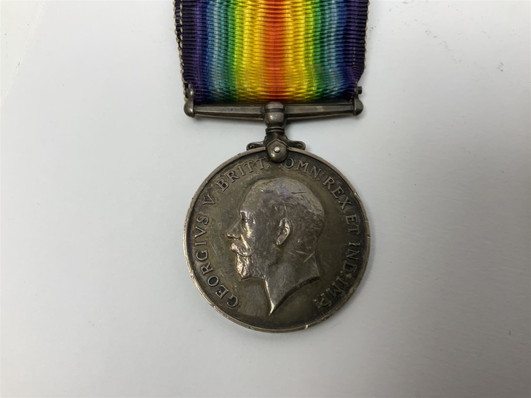 WW1 pair of medals awarded to 151761 Gnr. S. Loten R.A. with ribbons; four WW2 medals with ribbons; and small quantity of cap badges, medallions etc
